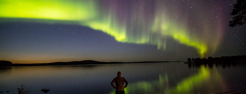 finland Lapland wilderness hotels autumn aurora man scaled