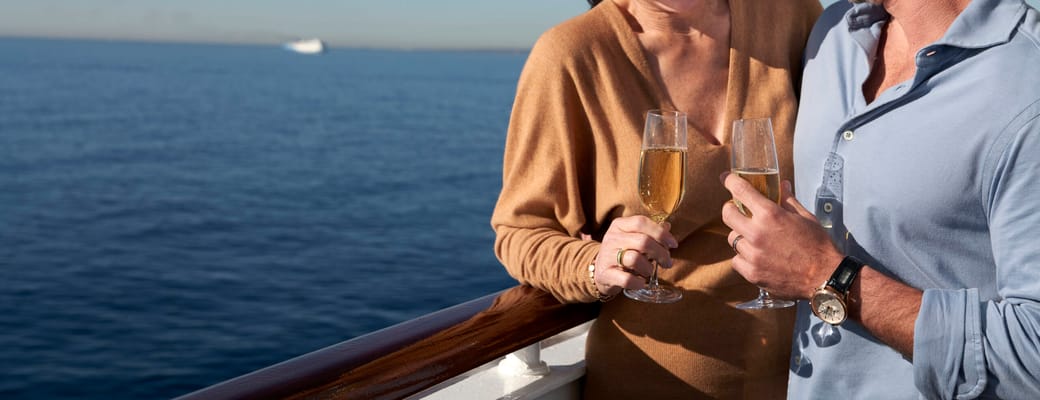 Par griner med champagne ved r&aelig;ling