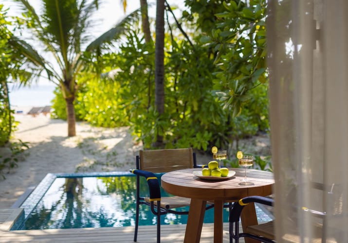 avani fares maldives beach pool villa dining poolside scaled